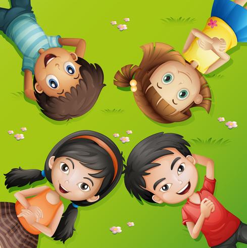 Four children lying on green grass vector