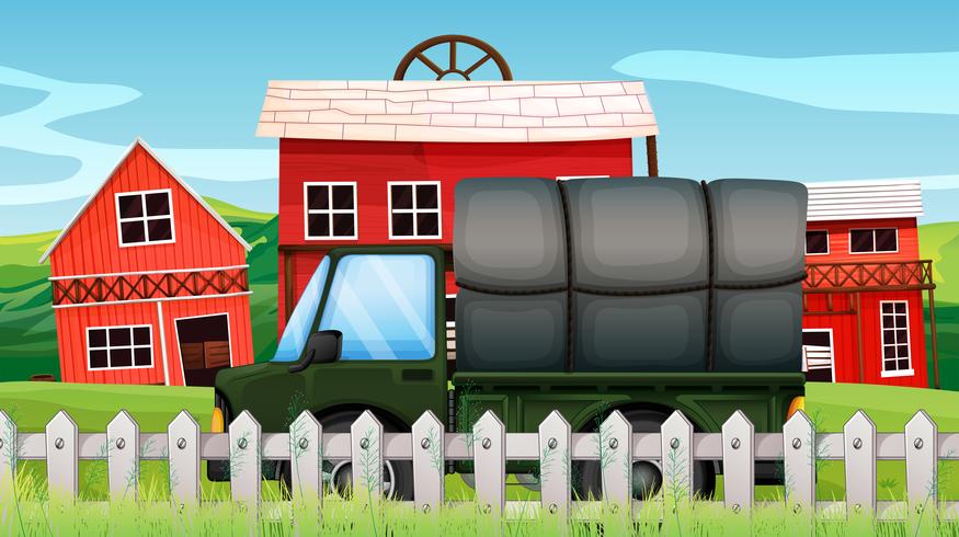 A green cargo in front of a barn inside the fence  vector