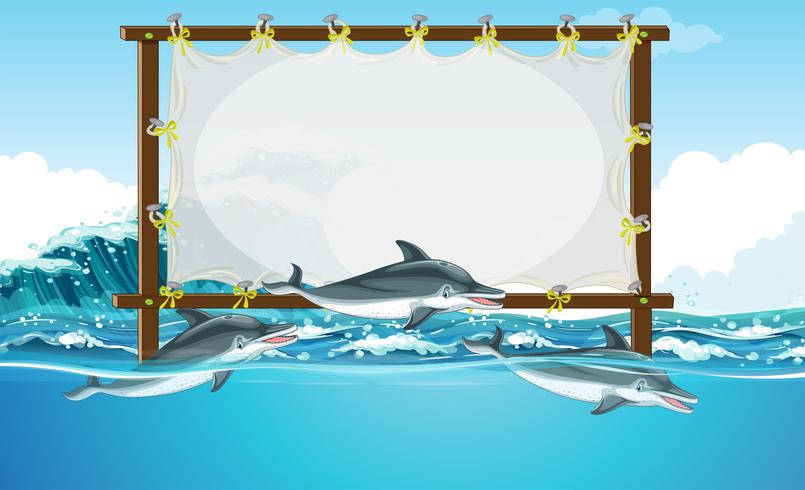 Diseño de borde con tres delfines nadando. vector