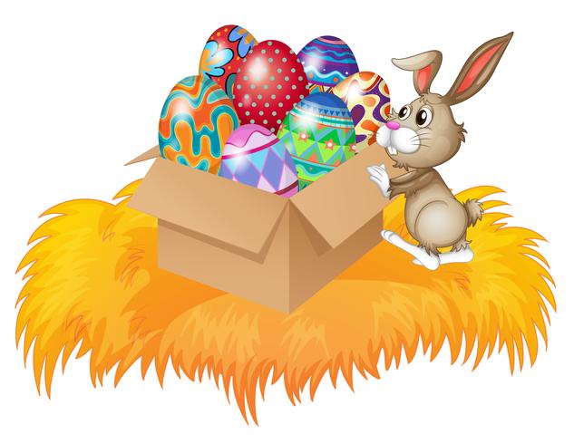 A bunny pushing a box full of easter eggs vector