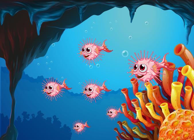 Una escuela de peces globo dentro de la cueva del mar. vector