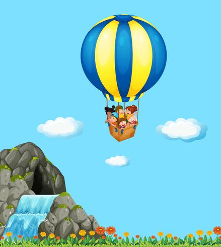 Children riding on balloon in the sky vector