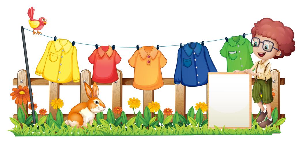 A boy holding an empty frame in front of the hanging clothes vector