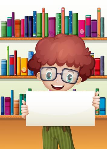 A boy holding an empty cardboard standing in front of the bookshelves vector