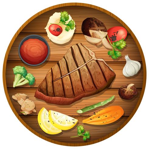 Steak dinner on round platter vector