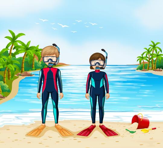 Two scuba divers in wetsuit standing on beach vector