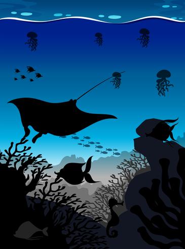 Silhouette scene with stingray and fish underwater