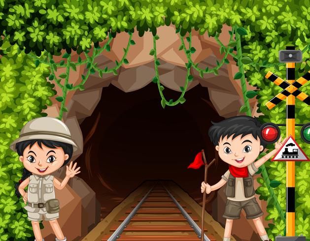 Niño y niña exploradora frente a túnel vector