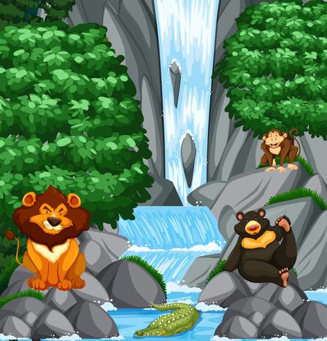 Escena de cascada con muchos animales salvajes vector