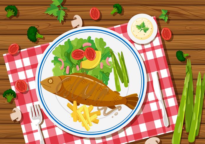 Pescado a la plancha y ensalada en el plato. vector