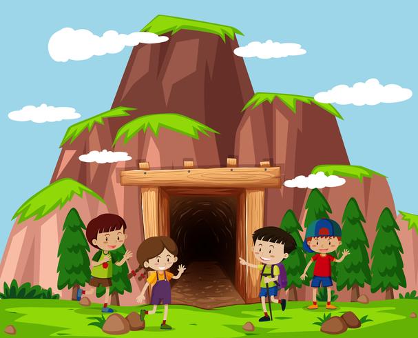 Niños felices frente a la cueva vector