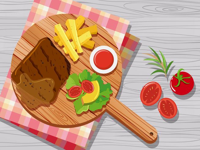Steak and vegetables on cutting board vector