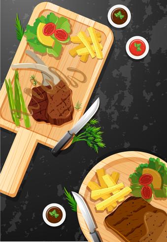Steak and fries on wooden board vector