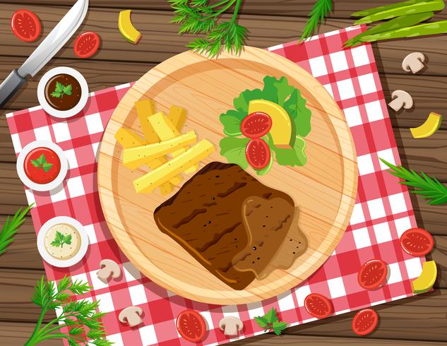 Steak with fries and salad on the plate vector