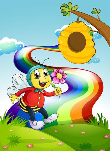 Una abeja sonriente sosteniendo una flor en la cima de la colina con un arco iris vector