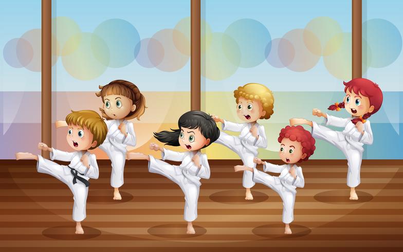 Niños practicando karate vector