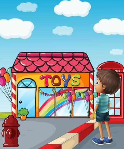 Un niño parado cerca de la juguetería. vector