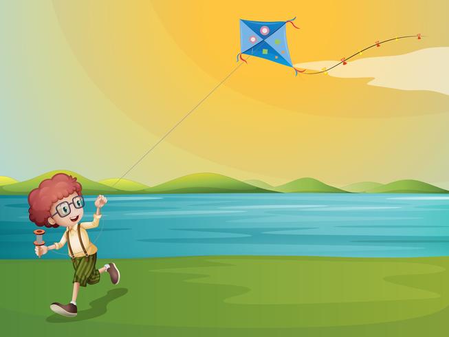 A young boy playing with his kite at the riverbank vector