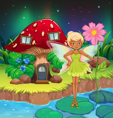 A fairy holding a flower near the red mushroom house