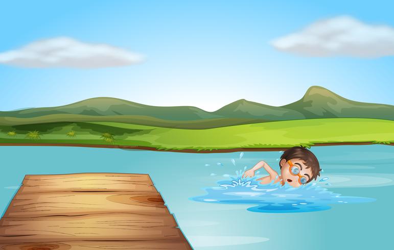 A boy swimming near the diving board