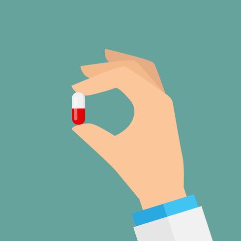 Hand holding a pill vector