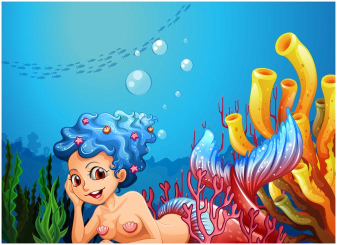 A mermaid near the coral reefs vector