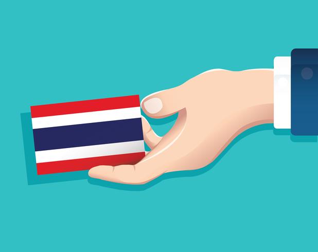 mano que sostiene la tarjeta de la bandera de Tailandia con fondo azul vector