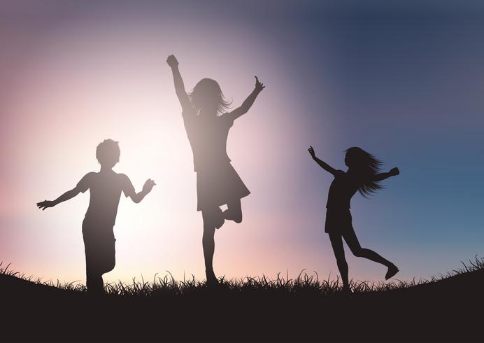 Silhouettes of children playing against sunset sky vector