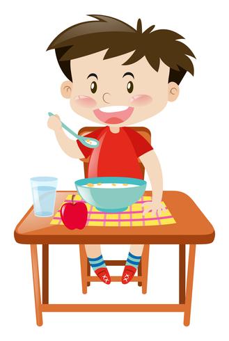 Niño comiendo del tazón en la mesa vector