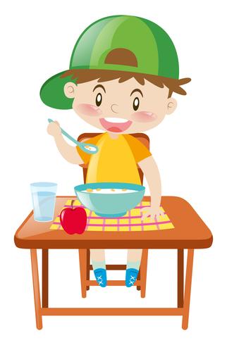 Little boy at dining table eating breakfast vector