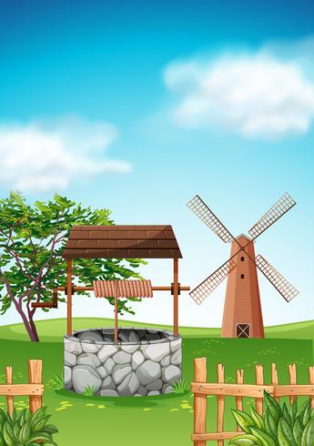 Scene with windmill and well in the farm vector