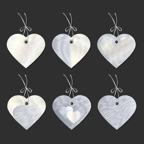 A set of tags in the form of hearts. Embroidery. Vector