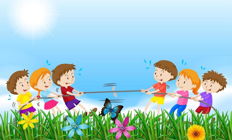 Children playing tug of war in a field