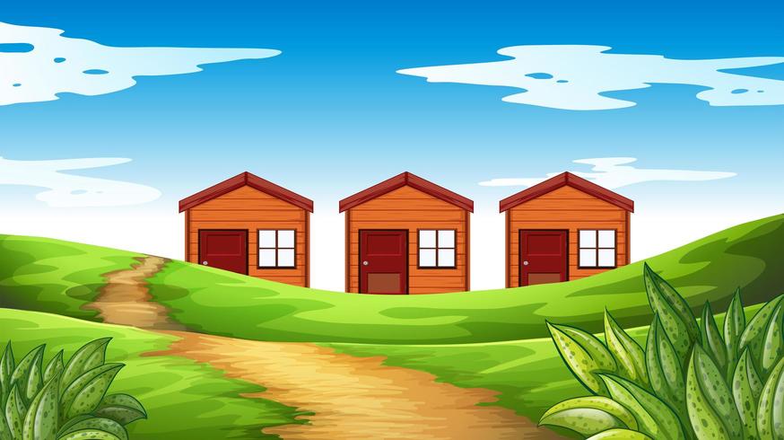 Tres casas de madera en el campo. vector