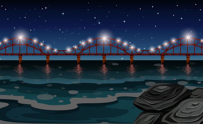 Ocean scene with bridge at night vector