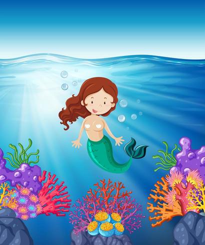 Mermaid swimming in the sea vector