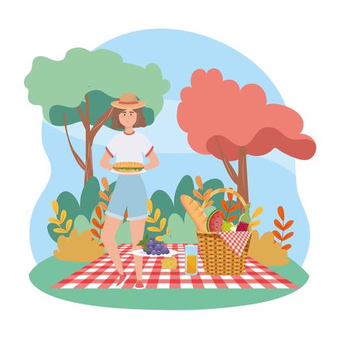 Mujer en picnic con sandwich y cesta vector