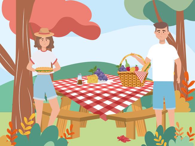 Mujer y hombre con picnic en la mesa vector