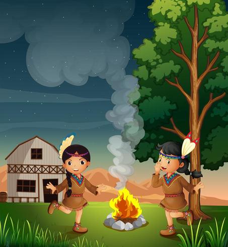 Two little Indians with a campfire vector