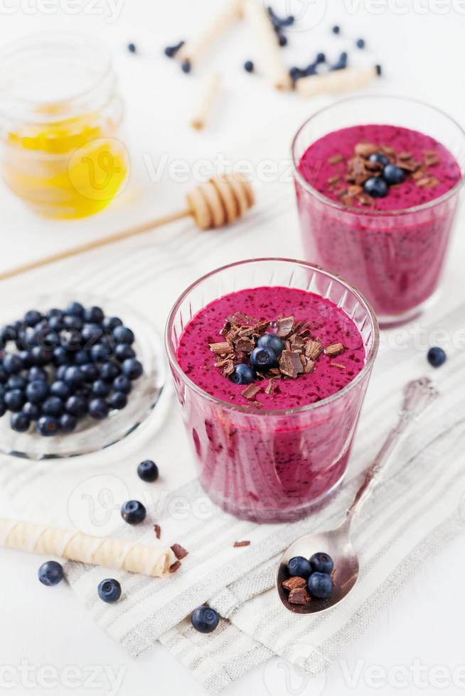 berry smoothie, milkshake, yogurt, docorated grated chocolate, honey and blueberry photo