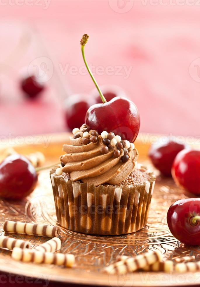 Chocolate cupcake with cherries photo