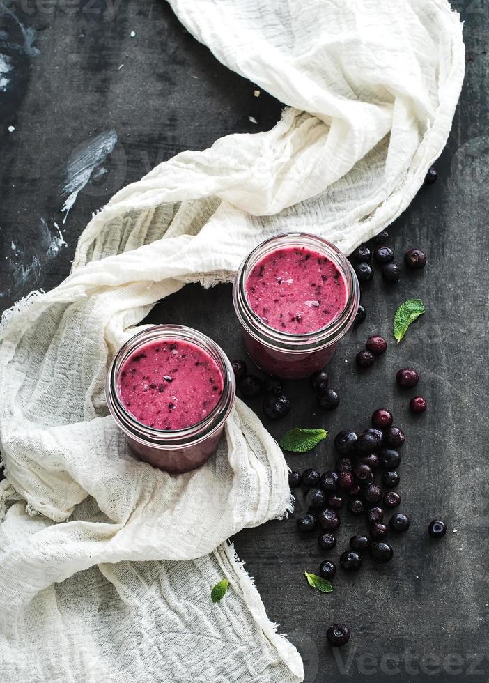 Fresh healthy smoothie in glass jars with blueberries and mint photo