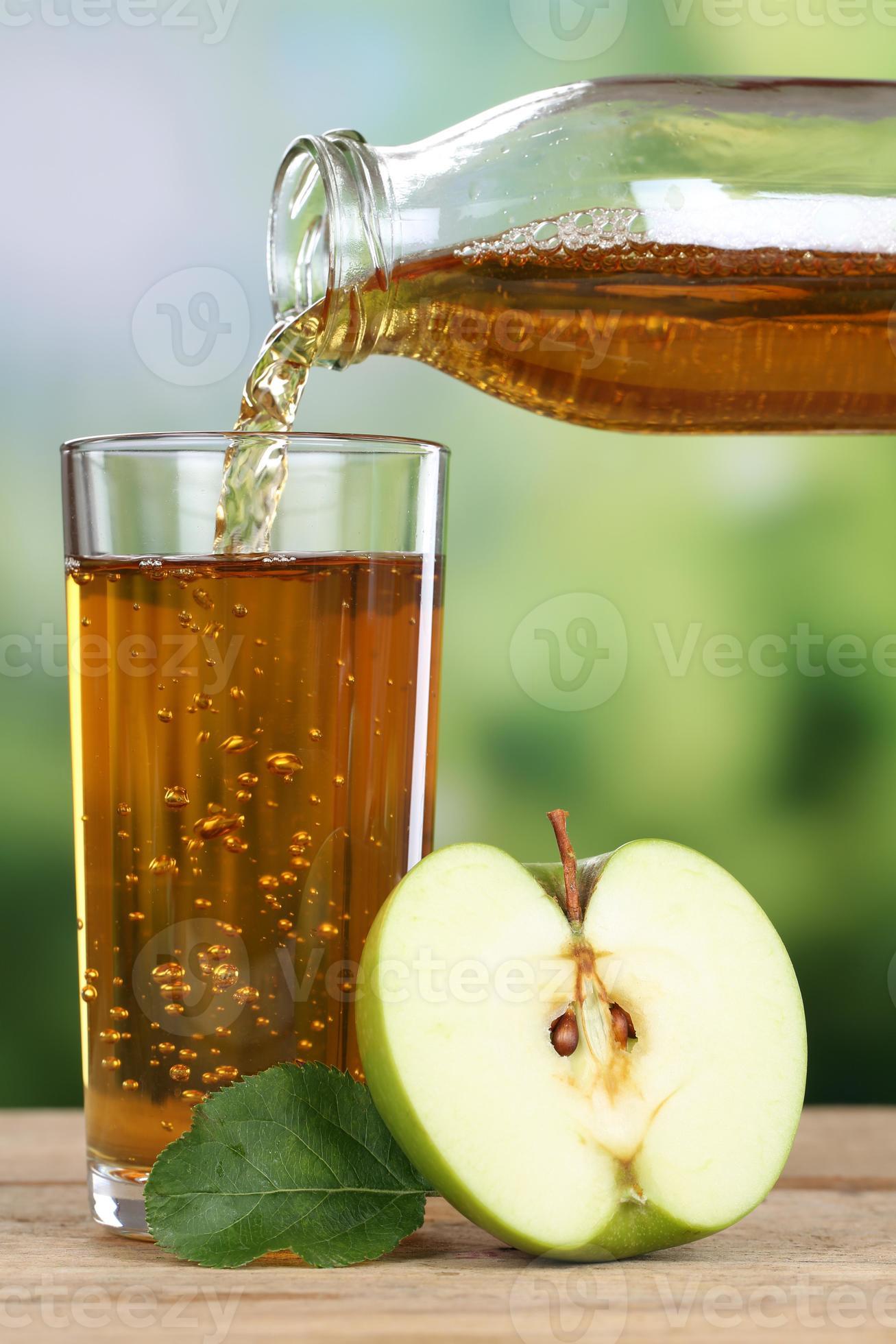 Healthy drinking apple juice pouring from apples into a glass 709288