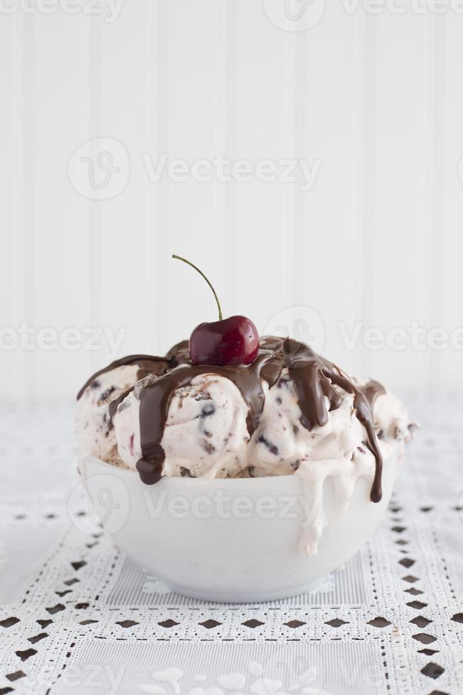 bowl of ice cream with cherry on top photo