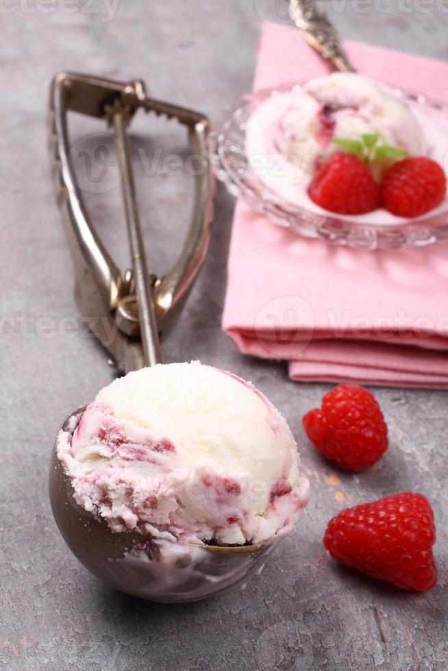 Scoop with berry ice cream and raspberry photo