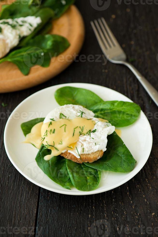 Poached egg on a piece of bread with spinach photo