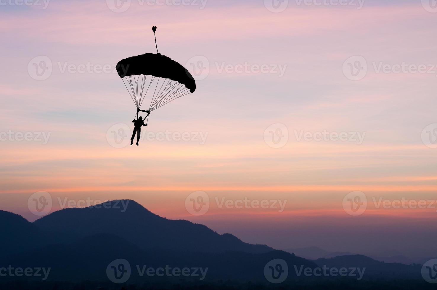 parachute at sunset silhouetted photo
