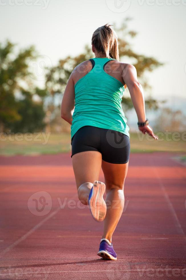Female runner on an athletics track photo