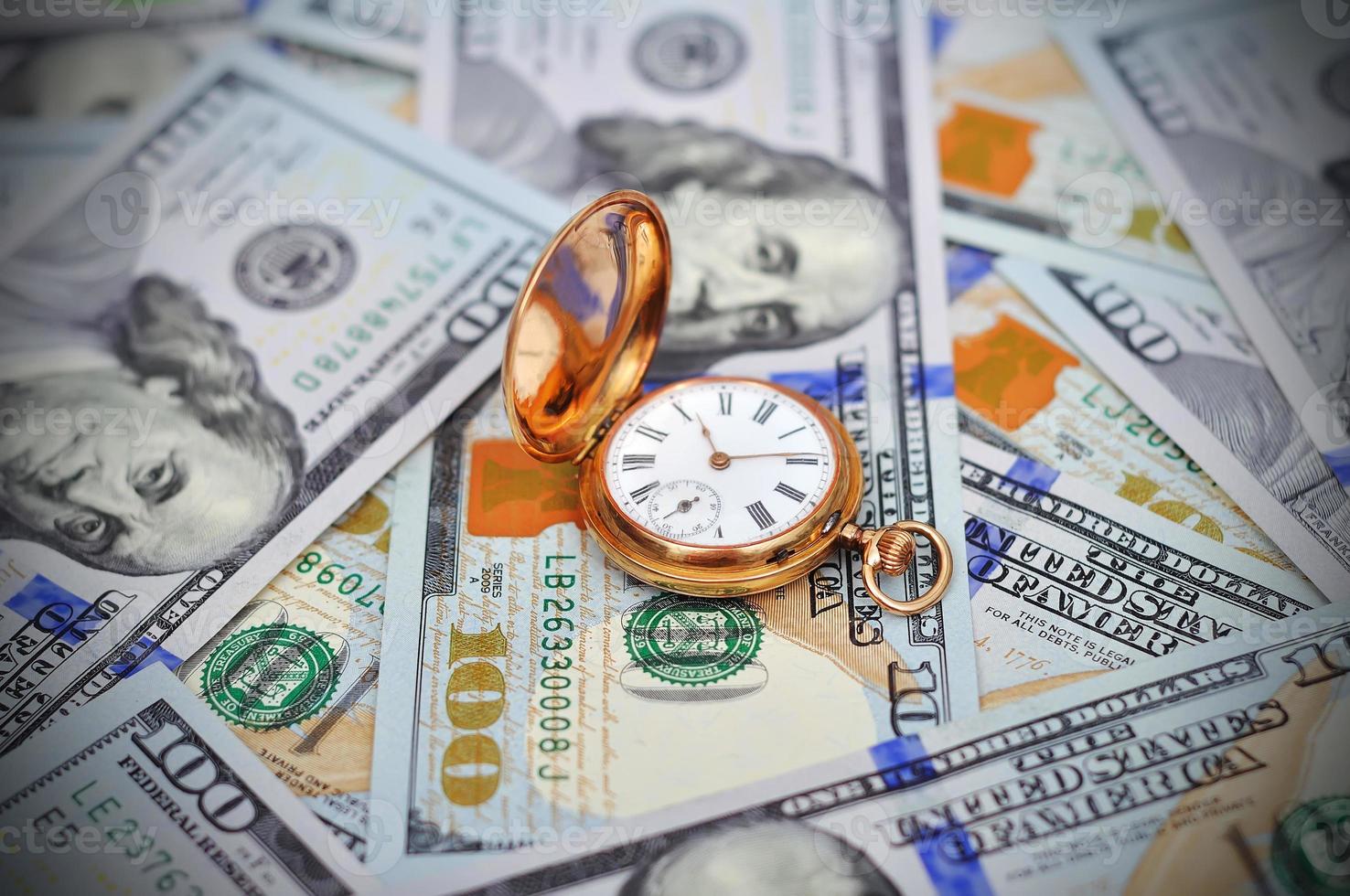 Money and antique watch photo