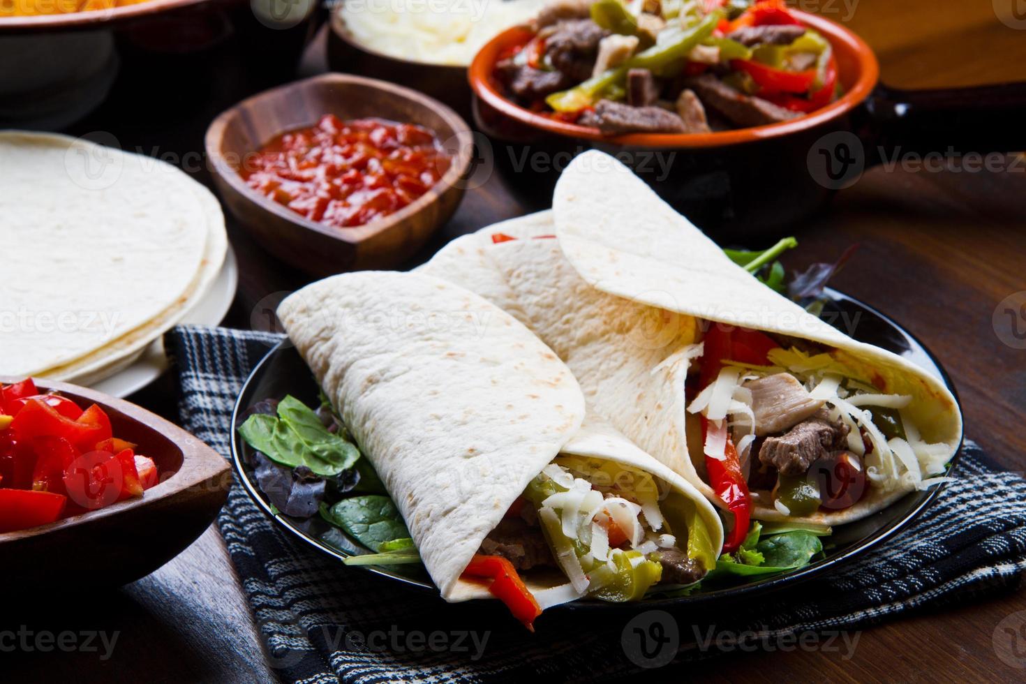 homemade Chicken  Beef Fajitas with Vegetables and Tortillas photo